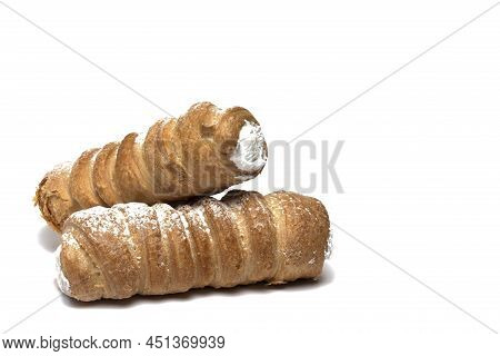 Close Up Of Two Foam Rolls Of Traditional Sweet Dessert Made Of Puff Pastry With Sugar Whipped Cream