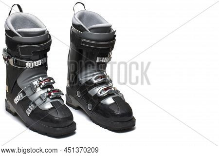 Close Up Of A Pair Of Two Black Ski Boots With Gray Lining And Three Buckles Standing Next Each Othe