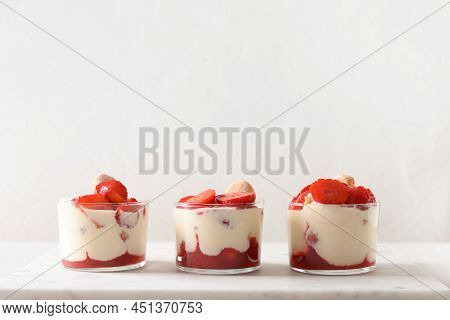 Three Portion Of Layered Dessert In Glass Jars With Cookie Savoyardi, Mascarpone Cheese And Whipped 