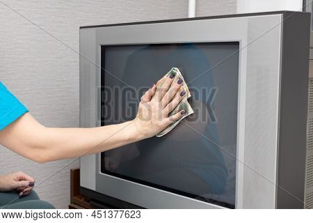 A Woman Wipes A Kinescope Of An Old Tv With A Chopper. High Quality Photo