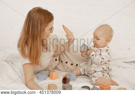 Glad Woman, Mother In Glasses And Child Playing Together With Toy Cubes And Shapes. Giving High Five
