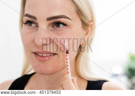 Mesotherapy In The Neck And Chest-neckline. Traces Of Hyaluronic Acid Injections. Light Background