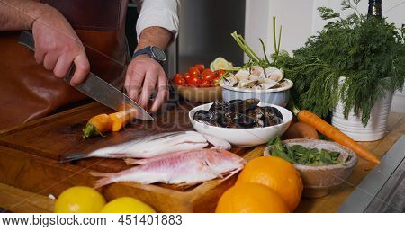 Process Of Mediterranean Dish Preparation. Fresh Mollusks Fish Shell Shrimp. Cooking Seafood.