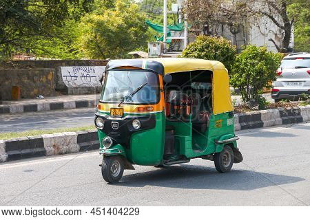 New Delhi, India - February 25, 2022: Green Auto Rickshaw Bajaj Re In A City Street.