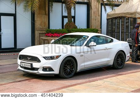 New Delhi, India - February 25, 2022: White Luxury Car Ford Mustang In A City Street.
