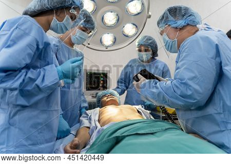 Medical Team In Surgical Gown Help Patient To Making Cpr Cardio Pulmonary Resuscitation In The Opera