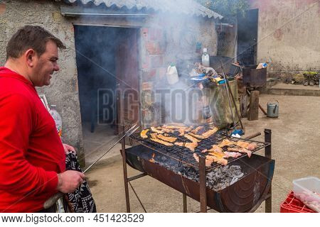 PAREDES DE COURA, PORTUGAL - MARCH 07, 2022: Butcher killed pig for old traditional ceremony in the north of Portugal