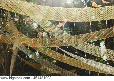 Golden Dharmacakra Flags Near An Ancient Buddhist Pagoda In A Deep Forest, The Symbol Of Buddhism In