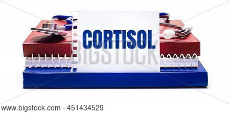 On A Light Background Notepad, A Stethoscope And A White Card With The Text Cortisol. Medical Concep