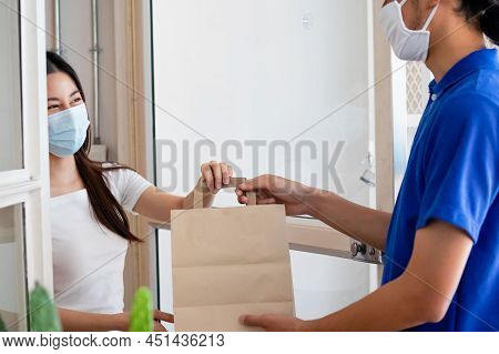 Young Asian Woman, Customer Wearing Face Mask Protect To Pandemic Of Covid And Received Bag,cardboar
