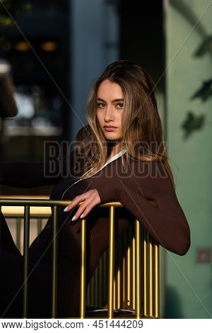 Portrait Of A Fashionable Young Brunette Woman Wearing Solid Long Sleeve Bodycon One Piece Jumpsuits