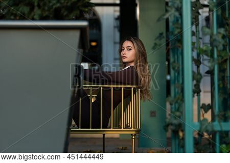 Portrait Of A Fashionable Young Brunette Woman Wearing Solid Long Sleeve Bodycon One Piece Jumpsuits