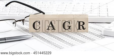 Cagr Written On Wooden Cube With Keyboard , Calculator, Chart,glasses.business
