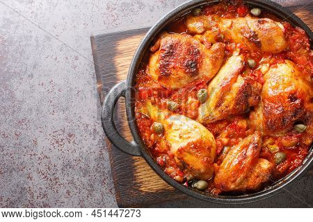 Pieces Of Chicken Baked With A Sauce Of Tomatoes, Peppers, Onions And Garlic Close-up In A Frying Pa