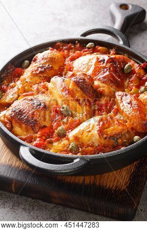 Baked Chicken With Sofrito Vegetable Sauce Close-up In A Frying Pan On The Table. Vertical