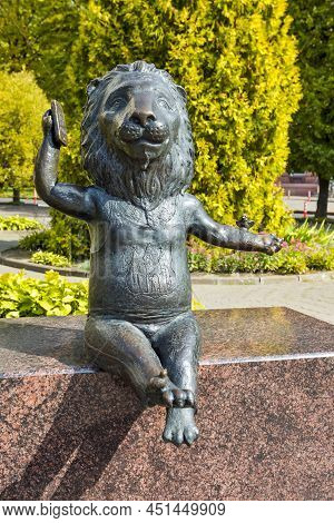 Mogilev, Belarus - September 11, 2021: Bronze Metal Statue Of Funny Lion Speaking On Cellphone As A 