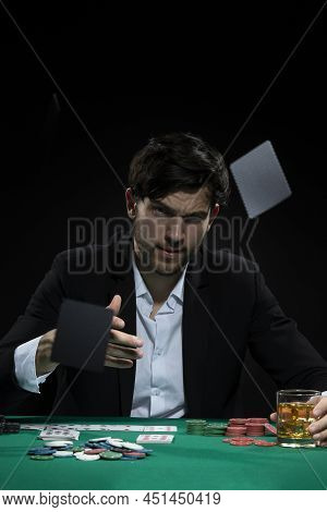 Concentrated Handsome Caucasian Brunet Young Pocker Player Throwing Cards To Win At Pocker Table Wit