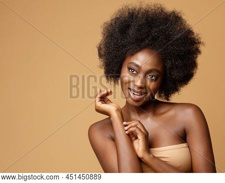 Happy African Beauty Model With Afro Hairstyle. Cheerful Smiling Woman With Dark Skin And Black Coil