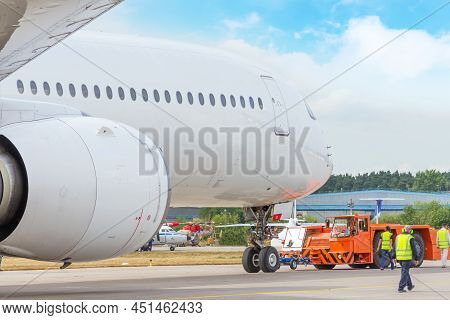 Pushback Truck Is Towing The Aircraft To A Parking Lot