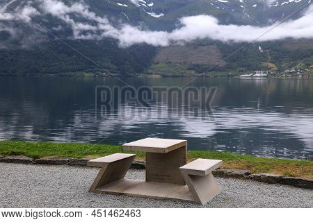 Picnic Table By The Fiord. Norway Landscape - Hardanger Fiord With Low Layer Of Clouds. Municipality