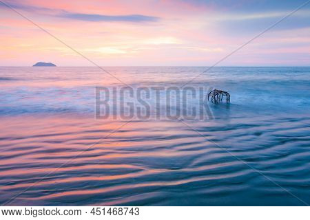 Seascape View Of A Tropical Beach At Sunset. Colourful Sunset Sky Reflection On Ocean Waves And Wavy