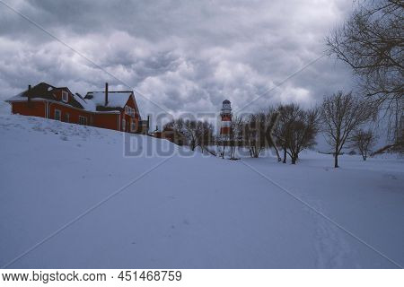 A Lighthouse And Red Houses Under Black Clouds In A Fishing Village. Shumashi. Ryazan Region. Russia