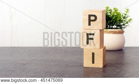 Letters Of The Alphabet Of Pfi On Wooden Cubes, Green Plant, White Background. Pfi - Short For Priva