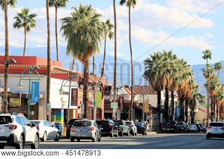 March 5, 2022 In Palm Springs, Ca:  Palm Tree Lights Lined Street With Retail Stores And Restaurants