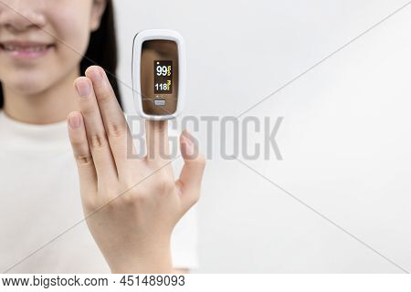 Hand Of Asian Child Girl With An Attached Pulse Oximeter On Fingertip,lady Measuring Heart Rate,chec