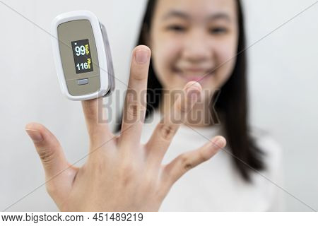 Hand Of Lady Girl With An Attached Pulse Oximeter On Finger Or Fingertip  For Examination Of The Lun
