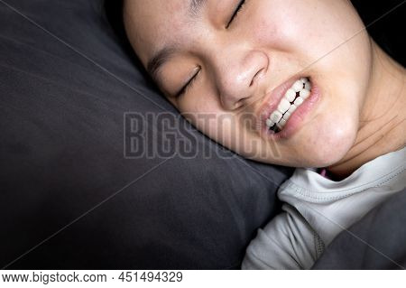 Asian Child Girl Suffering From Bruxism While Lying In Bed At Night,female Grinding Of The Teeth Dur