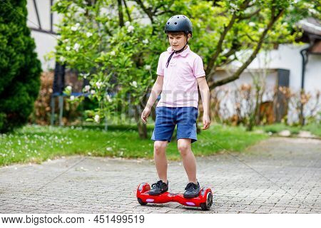 Active Kid Boy On Hover Board. Child Driving Modern Balance Hoverboard. Excercise And Sports For Chi