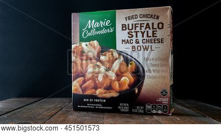 NORWALK, CT, USA - MARCH 23, 2022: Buffalo style mac and cheese paper box from Marie Callenders on wooden table near window