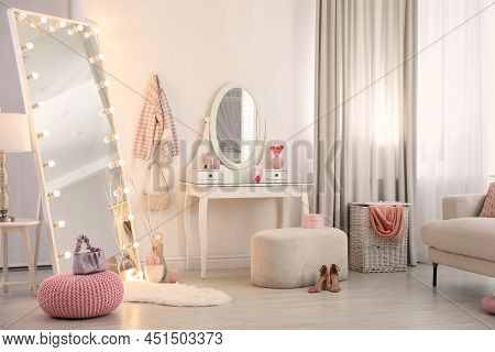 Large Mirror With Light Bulbs And Dressing Table In Stylish Room. Interior Design