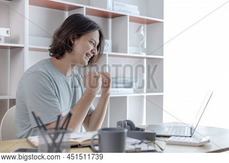 Joyful, Surprised or shocked Asian woman raised her arms all the way because she did a good job the 