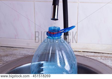 A Drop Of Pure Water Dripping From The Tap. Selective Focus. High Quality Photo