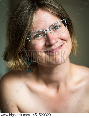 Smiling White Thrity Year Old Woman With Bare Shoulders And Glasses, Brussels