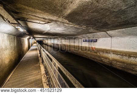 Anderlecht, Brussels, Belgium - 07 16 2019- The Covered River La Senne, With A Metal Walking Path At
