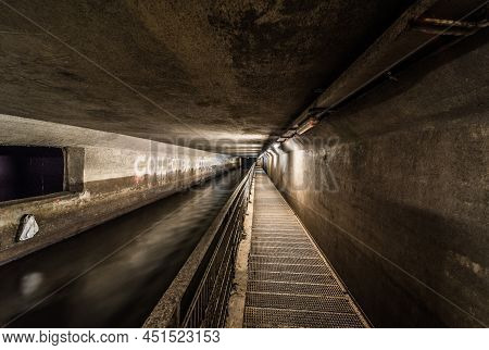 Anderlecht, Brussels, Belgium - 07 16 2019- The Covered River La Senne, With A Metal Walking Path At