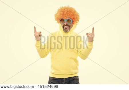 Funky Party. Bearded Man Wear Funky Wig. Nerdy Look. Showing Sign Of Horns. Heavy Metal Culture