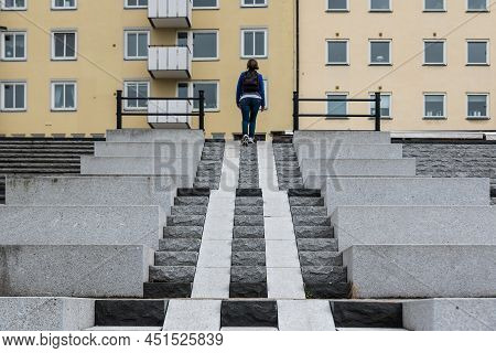 Sundsvall, Vastnorrland County - 08 02 2019: Woman Walking Up The Stairs In Old Town