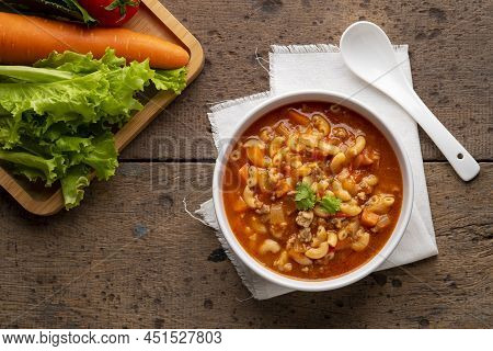 Beef And Tomato Macaroni Soup In White Bowl On Wood Table.top View