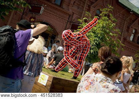 Klin, Russia July 26 2014. City Holiday - Carnaval. Dancing Man In A Black And Red Suit. Editorial D