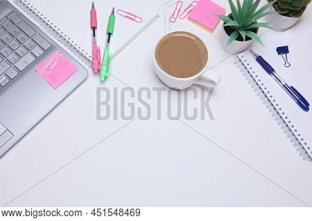 Office Table With Laptop, Notebook And Cup Of Coffee