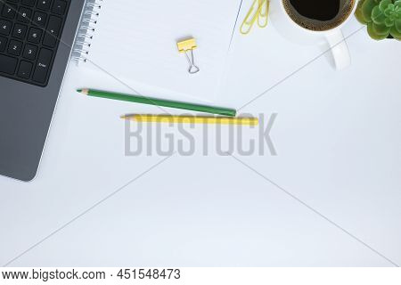Top View Of Working Place With Laptop, Notebook And A Cup Of Coffee