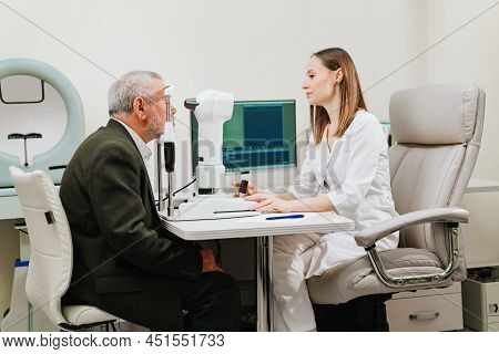Ophthalmologist Examination Of Elderly Man On Corneo Topographer.modern Clinic