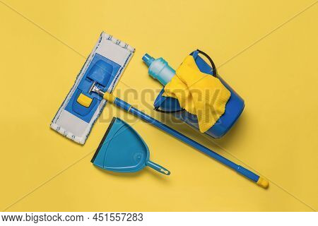 Yellow-blue Cleaning Kit On A Bright Yellow Background. Home And Office Cleaning Kit. The Concept Of