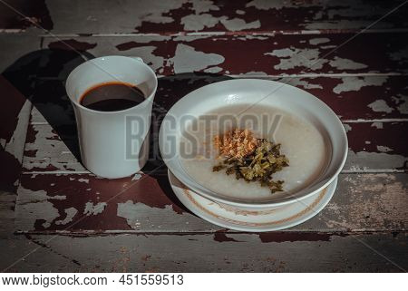 Pork Congee Or Rice Porridge With Minced Pork Sprinkled With Deep-fried Garlic And Coriander In Whit
