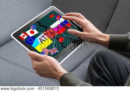 Ukrainian And Russian Flag On A Tablet And Inscription Attack.