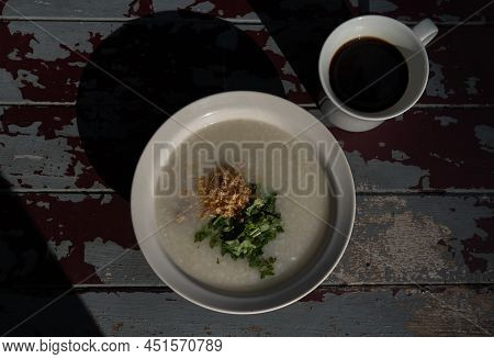 Pork Congee Or Rice Porridge With Minced Pork Sprinkled With Deep-fried Garlic And Coriander In Whit